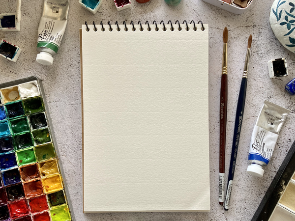 watercolor pad and art supplies